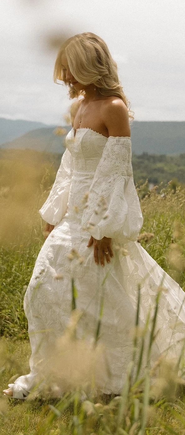 Model wearing a white gown on the field