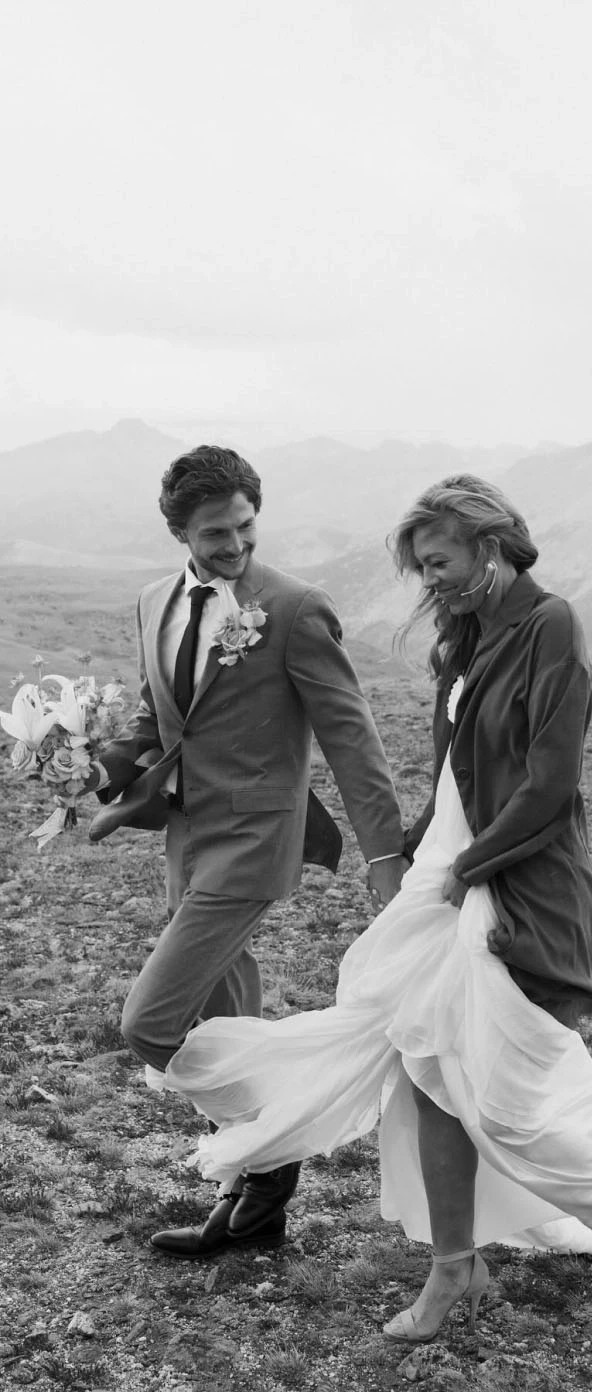 Сouple wearing a white gown and a black suit